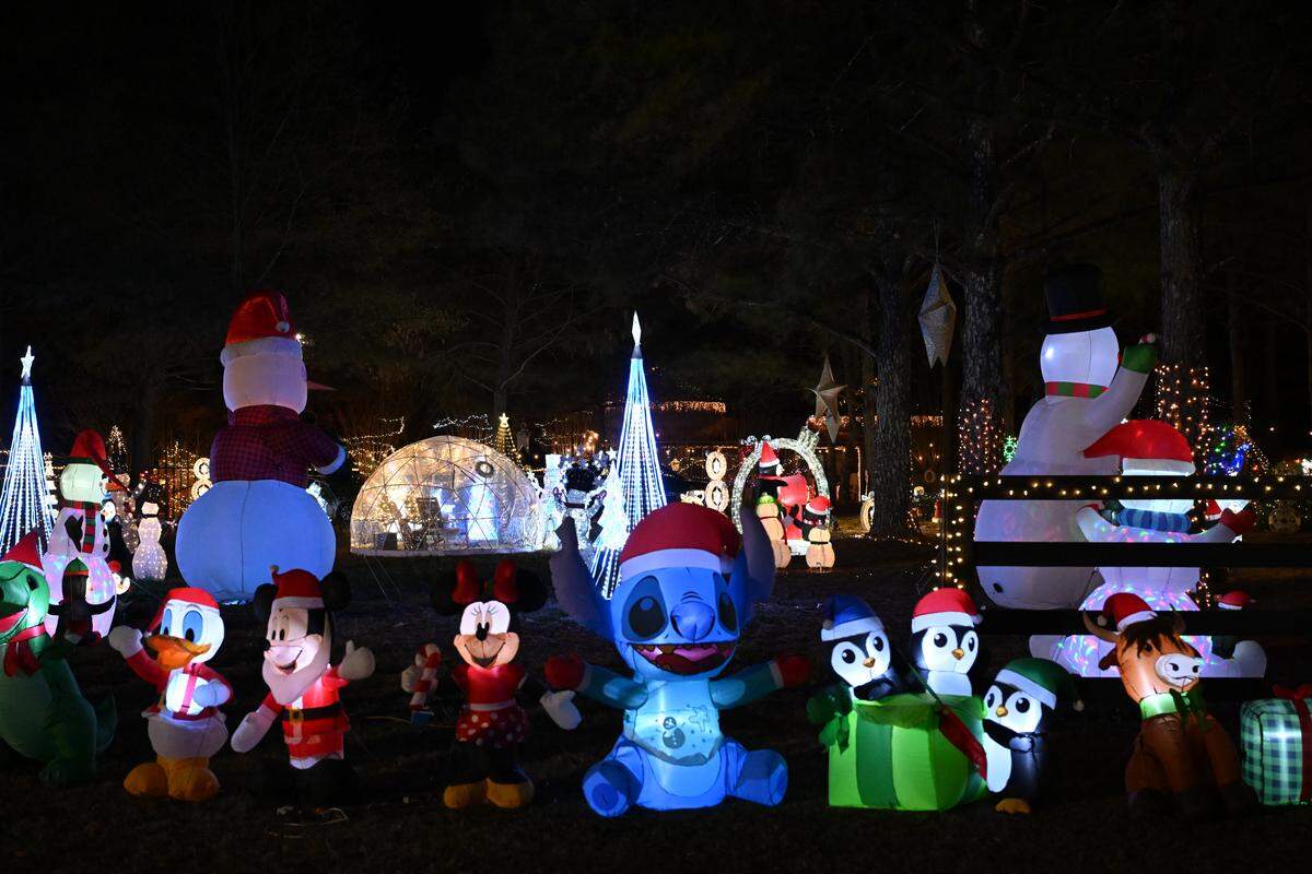 Inflatable characters stand inside the Silobrate Christmas Lights on Tuesday, Dec. 16, 2025, in Fort Valley, Ga. More than 100 festive inflatables and even more lights sit on Melissa Taylor’s property, which she opens to the public for a drive thru display. 