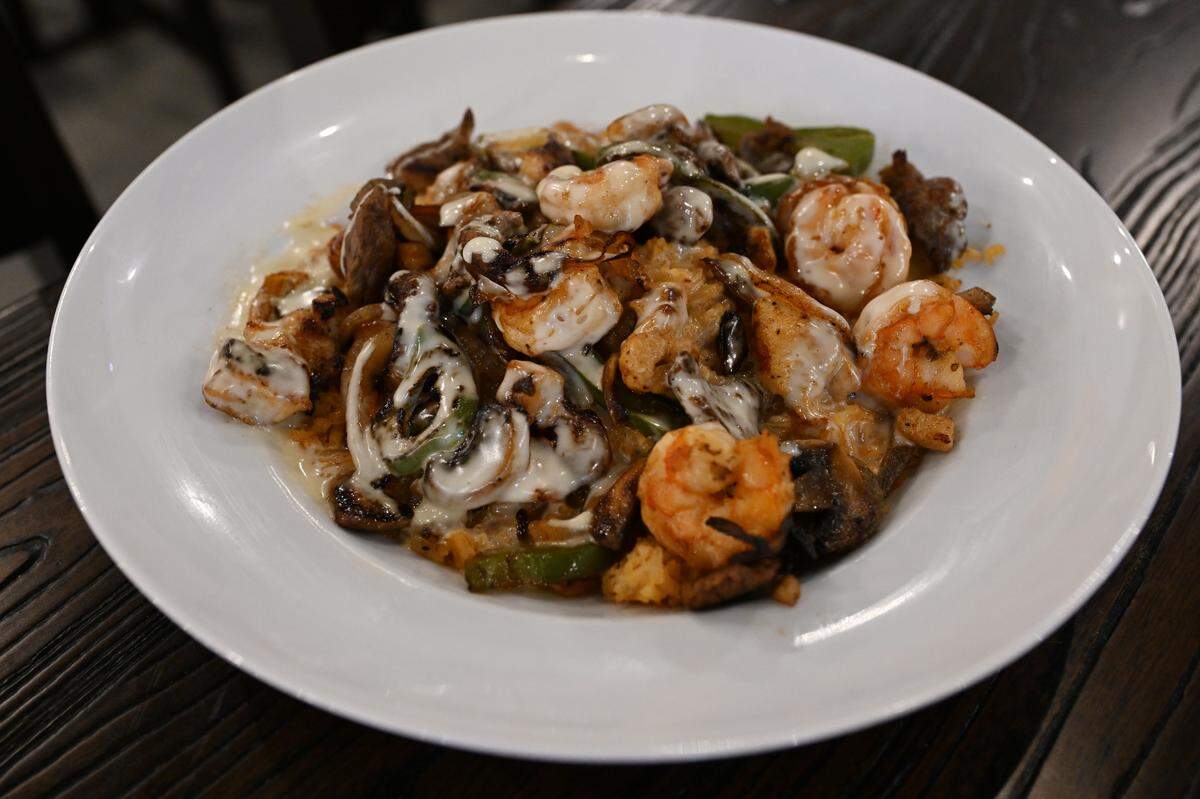 The Fuego special at Fuego Fresco Mexican Restaurant on Thursday, Aug. 28, 2025, in Perry, Georgia. The dish features a choice of grilled chicken, steak or shrimp, or all three meats as shown here, topped with onions, bell peppers, mushrooms and melted cheese.