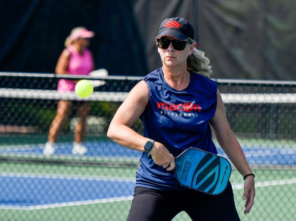 Maryann Bates returns a backhand while playing pickleball at the Tattnall Square Pickleball Center in Macon.