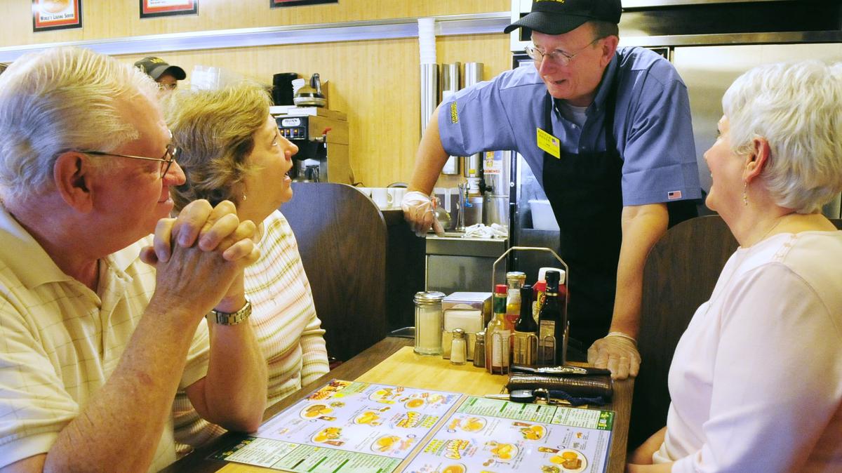 Ed Grisamore visit his friends Tom and Gayle Ward and Christie Pilcher while working at the Waffle House on Zebulon Road Oct. 14, 2010.