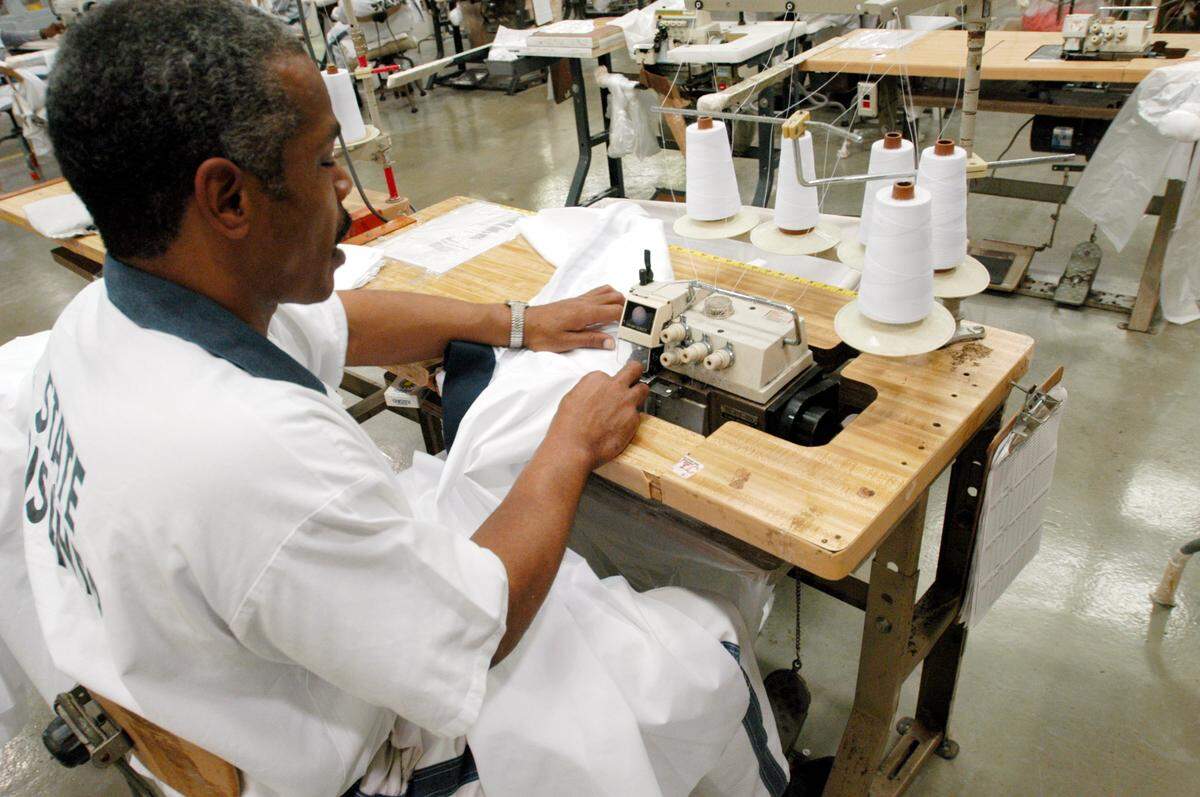 Lafayette Hall operating a sewing machine at his prison job.