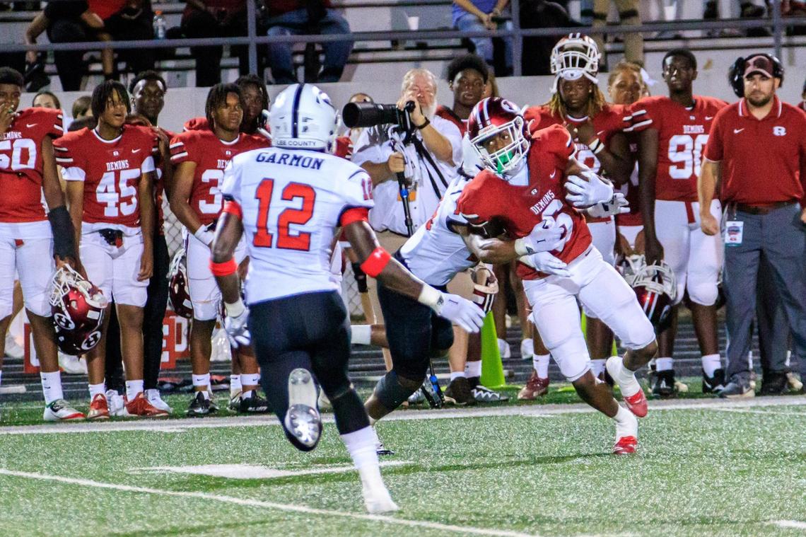 CLAY TEAGUE/FOR THE TELEGRAPH Warner Robins, GA, 8/19/22 Warner Robins’s Cam Flowers breaks a tackle on his way to score on a 50 yard touchdown pass from quarterback Chase Reese against Lee County.
