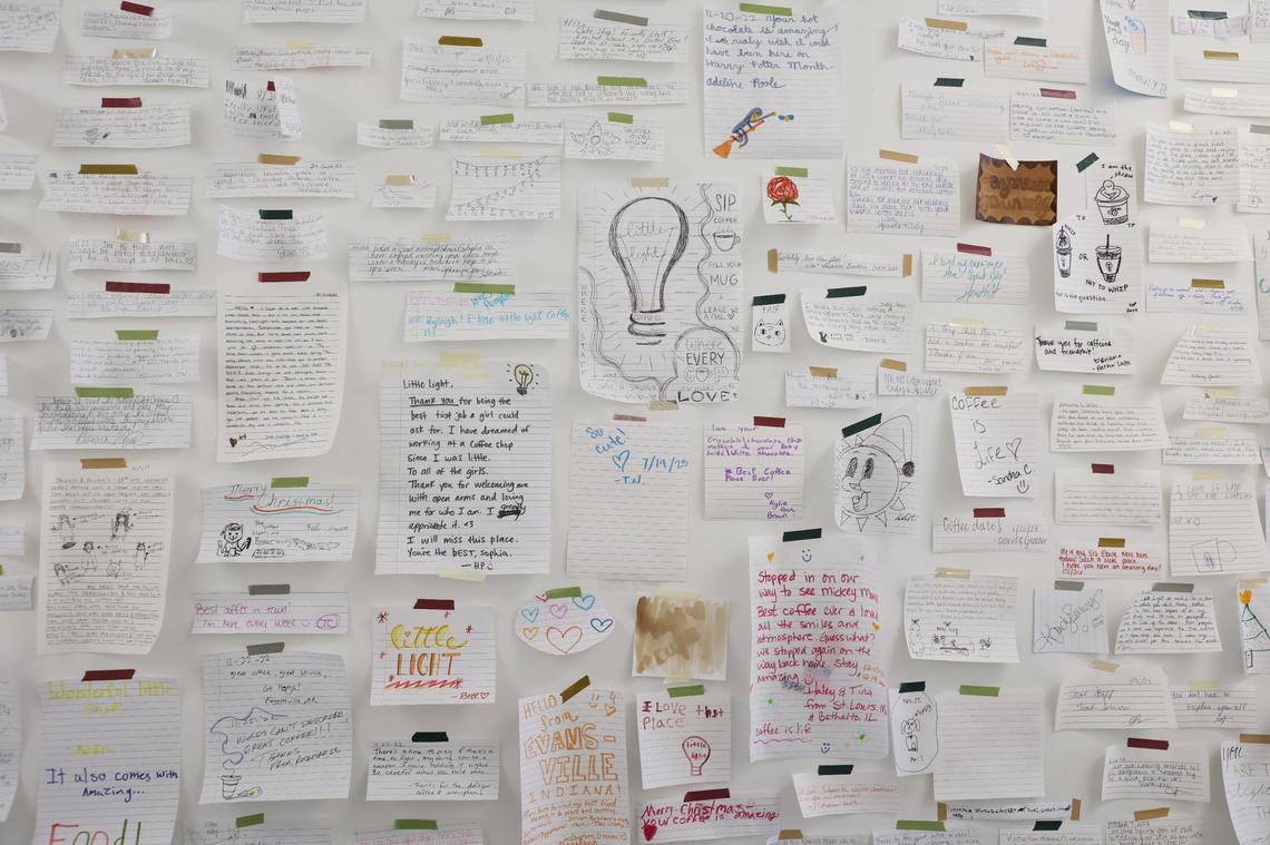 A wall of positive reviews and notes of support line the back hallway of Little Light Coffee Co. in Warner Robins.