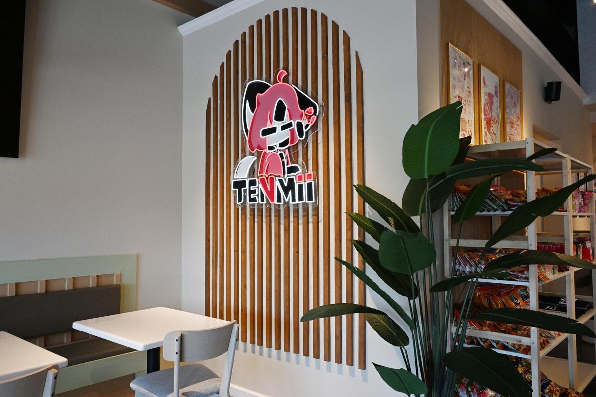 The logo for Tenmii Japanese Eatery hangs on the wall inside of its new location on Tuesday, May 6, 2025, in Warner Robins, Georgia. The name Tenmii comes from a Japanese word that translates to “to bring happiness to others.”