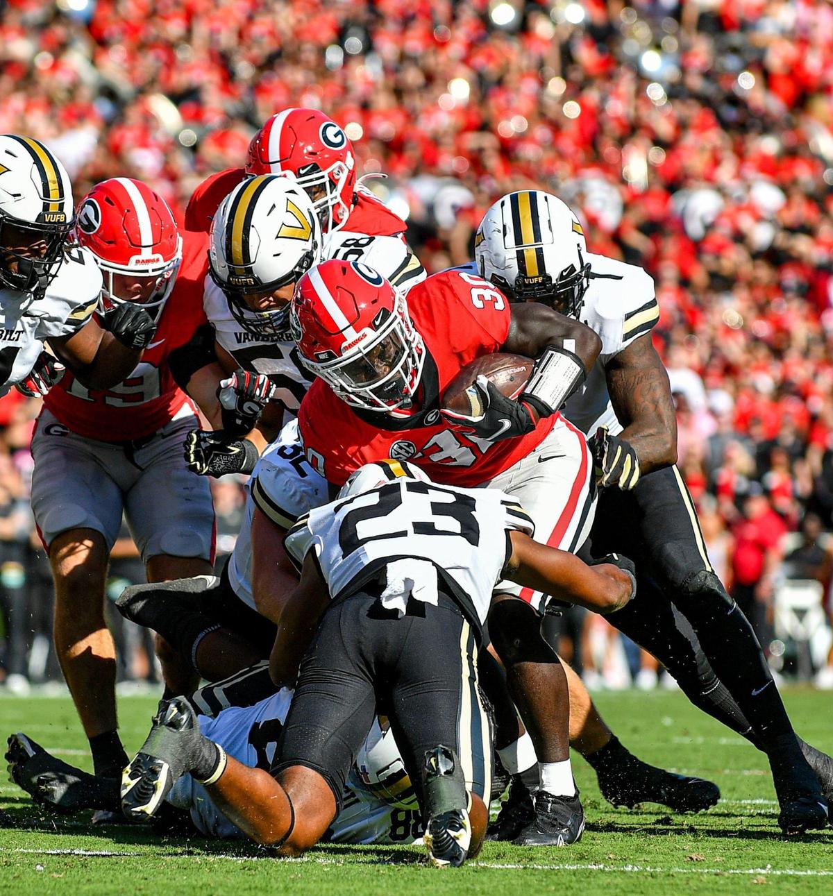 Georgia running back Daijun Edwards pushes his way through the Vanderbilt defensive line for a short gain in action Saturday in Athens.