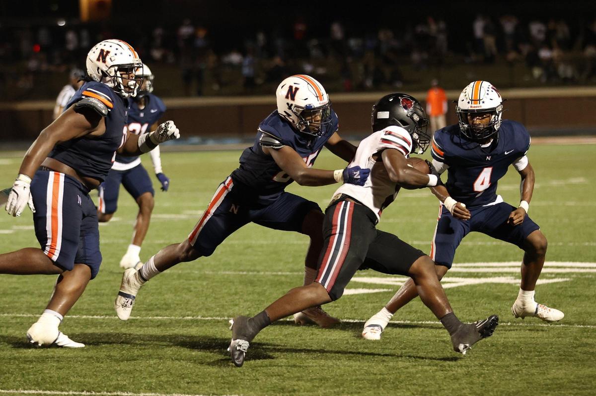 Northside High School senior cornerback Michael Clayton (4) and senior linebacker James Turner (25) attempt to start the Warner Robins ball carrier during the football game between Warner Robins and Northside High Schools on Friday, Aug. 30, 2024, at McConnell Talbert Stadium in Warner Robins, Georgia. The Warner Robins High School football team defeated the Northside High School team 34-12.