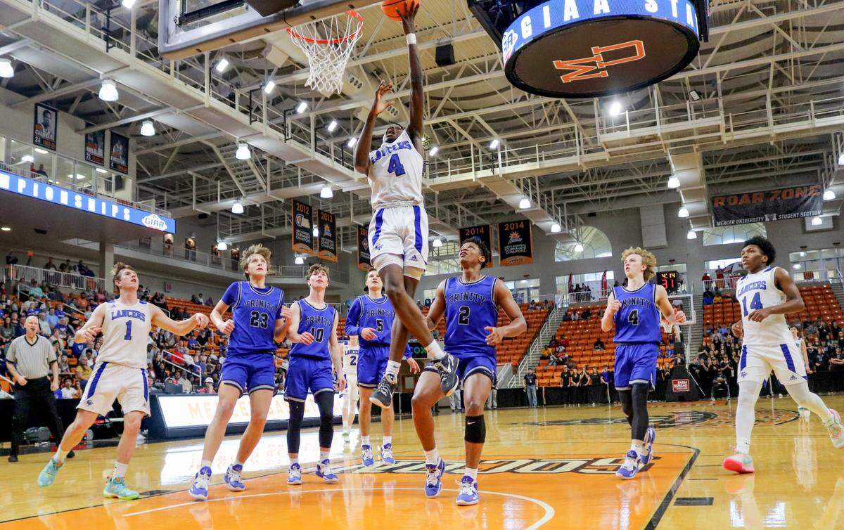 Central Fellowship guard Karez Demory (4) lays up the basketball during the Lancers’ 57-49 loss to Trinity Christian Saturday in the GIAA 2A Championship game.