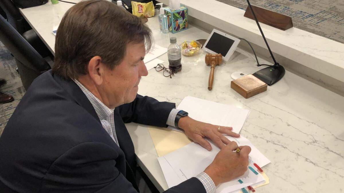 Macon Water Authority Chairman Gary Bechtel signs a supplemental bond resolution Thursday to fund $113 million in capital improvement projects for the utility.