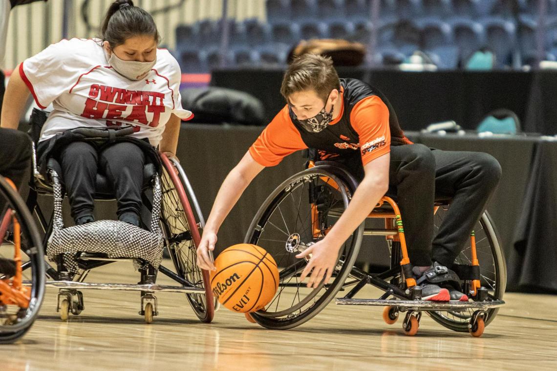 Houston County’s Dalton Crosby (3) scoops up a loose ball against the Gwinnett Heat in the GHSA Championship March 13.