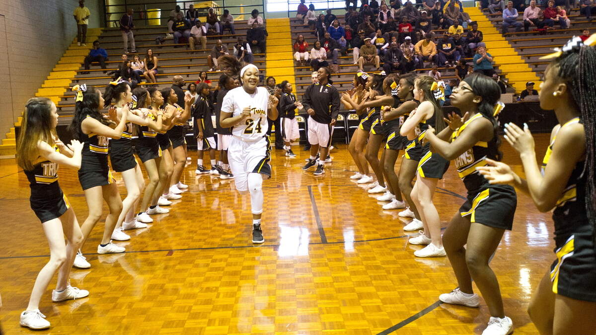 Peach County's Eboni Steele (24) runs through the cheerleaders as she is introduced before the game against Josey.