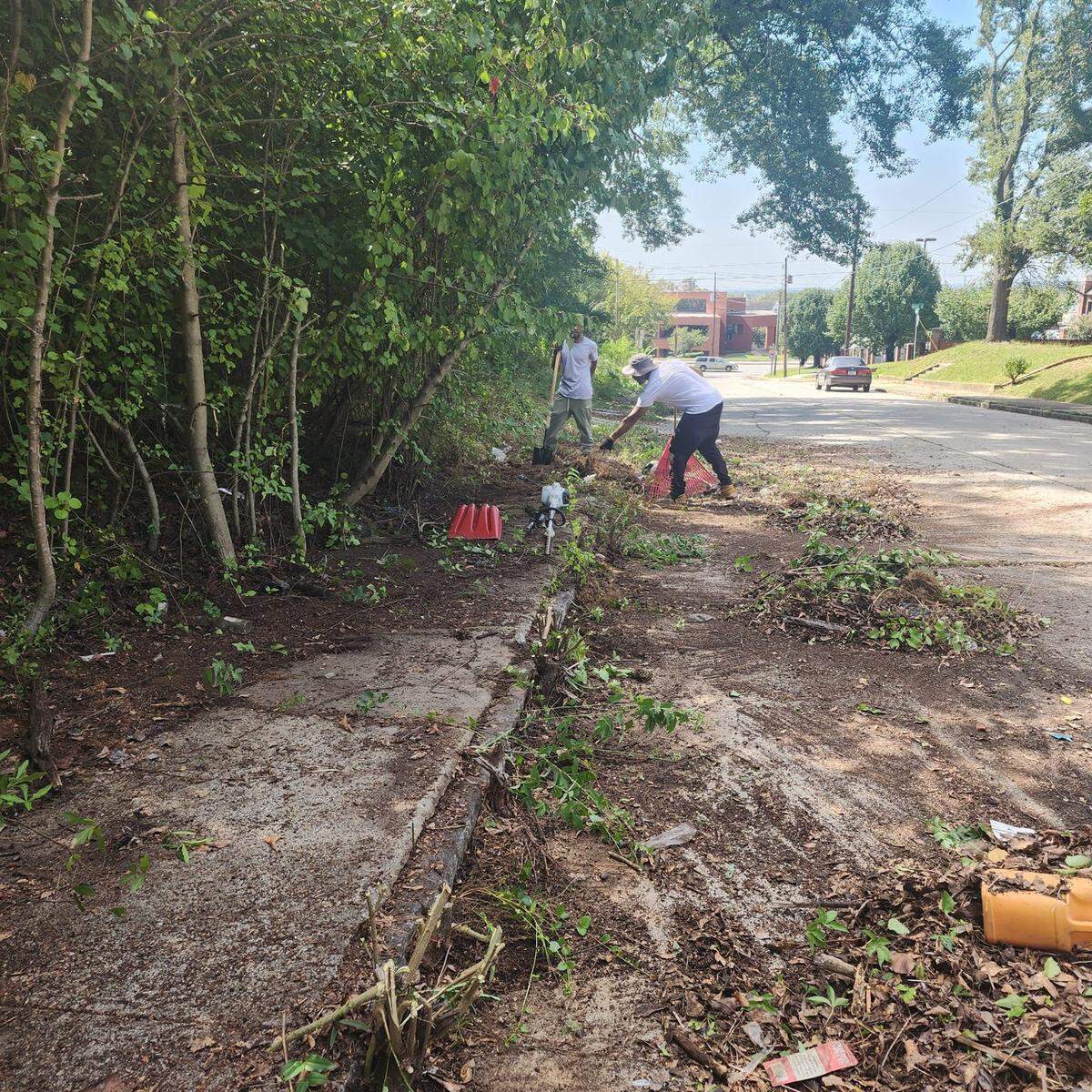 East Macon residents unite to trim overgrown sidewalks that interfere with student safety after ongoing complaints go unheard.