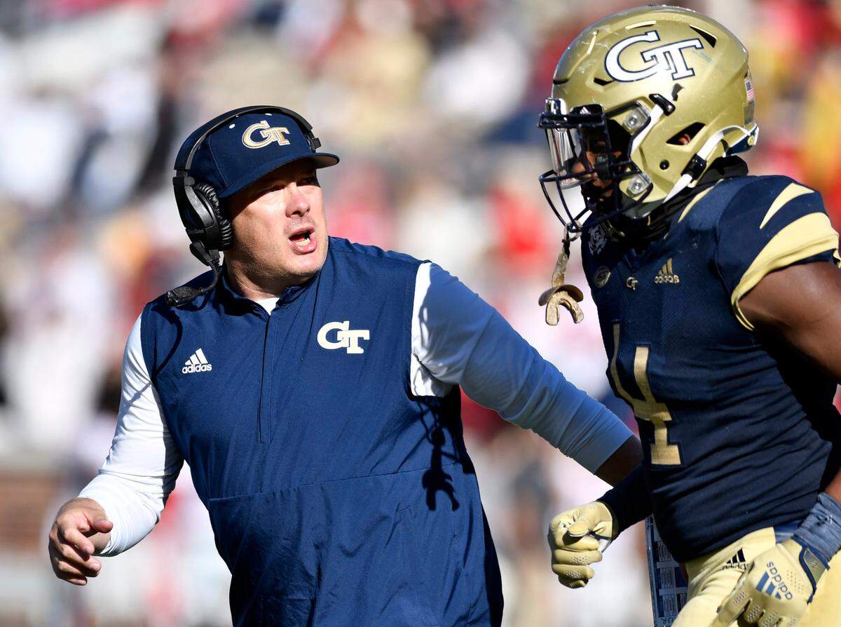Georgia Tech head coach Geoff Collins speaks with linebacker Quez Jackson (4) during the Yellow Jackets 45-0 loss to Georgia Saturday in Atlanta.