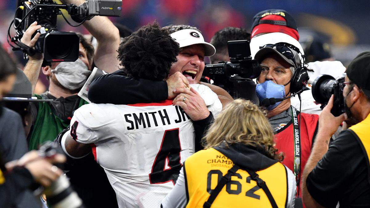 Georgia head coach Kirby Smart celebrates with Nolan Smith (4) after the Bulldogs’ 33-18 win over Alabama in the College Football Playoff National Championship game Monday night.