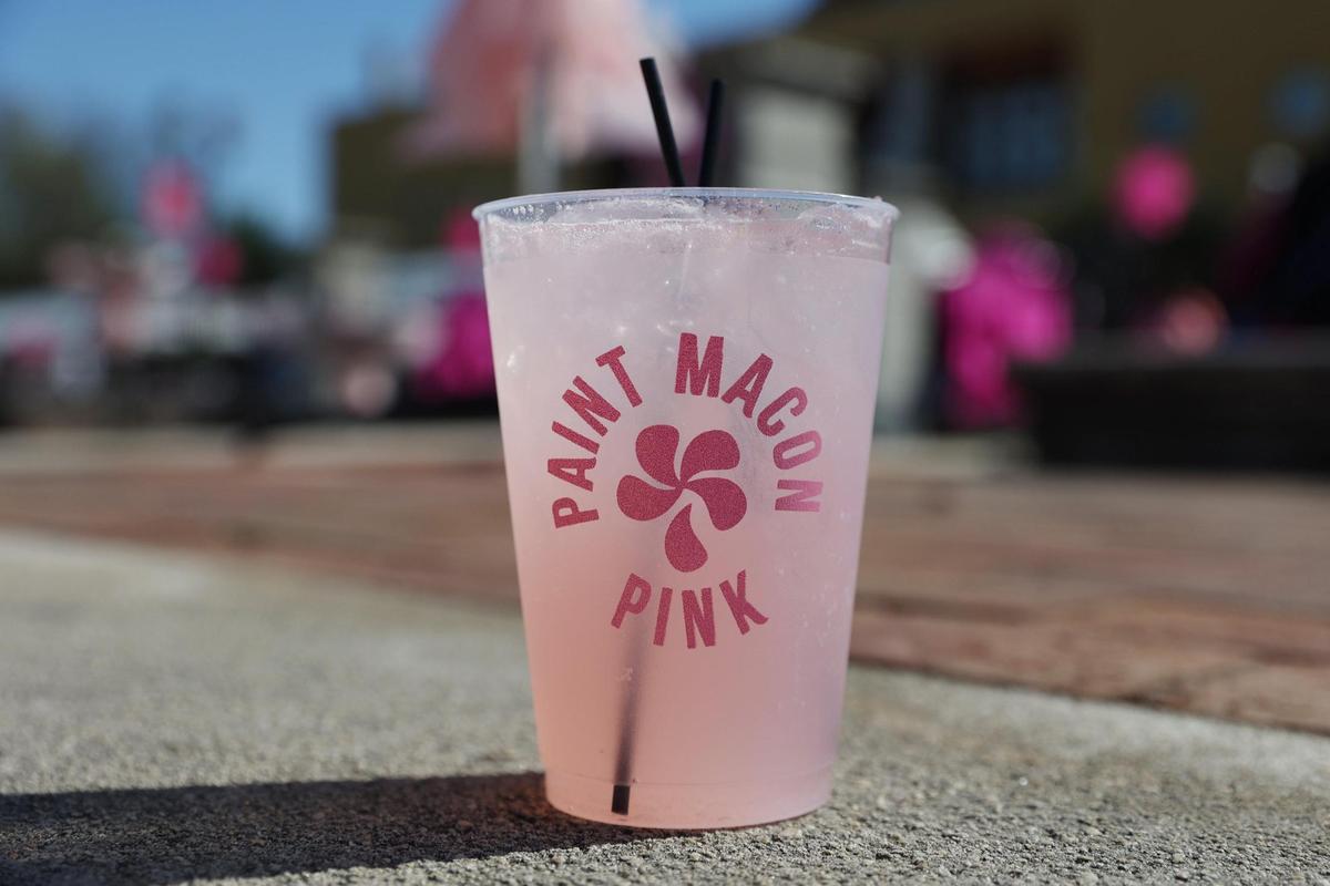 Pink Party Lemonade from Cashman’s Pub sits in the Third Street Plaza during the Pink Provisions Trail preview on Friday, March 21, 2025, in downtown Macon, Georgia. Local Macon restaurants and bars debuted pink bites and drinks to celebrate the International Cherry Blossom Festival, all of which are available throughout the festival.