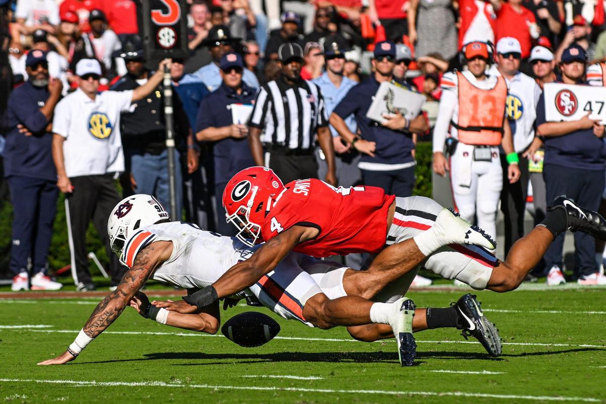 Auburn quarterback Robby Ashford was able to recover a high snap in action Saturday in Athens.
