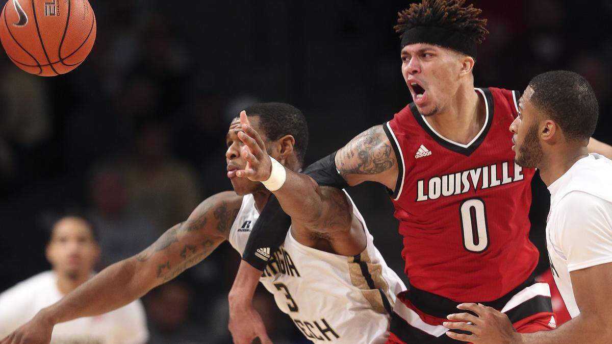 Louisville guard Damion Lee (0) and Georgia Tech guard Marcus Georges-Hunt chase a loose ball during the second half Saturday.