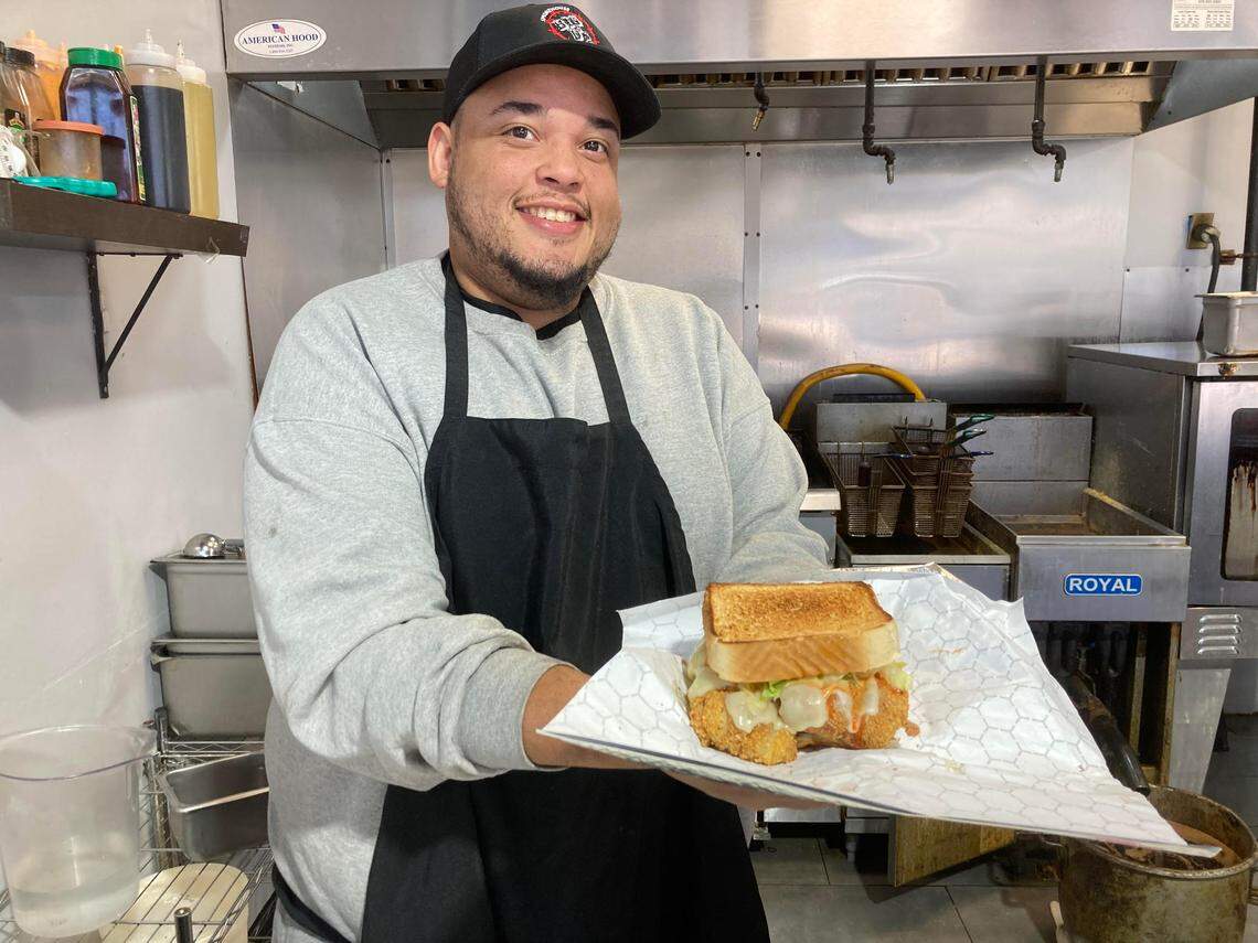 Cheno Stewart holds up a fish sandwich at Big D’s Bar-B-Q at 280 Carl Vinson Parkway in Warner Robins.