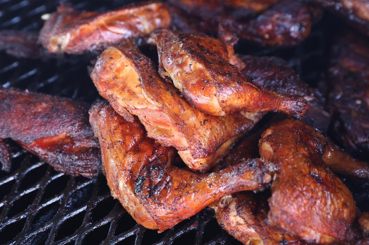 Barbecued chicken thighs sit on the grill at Q Time Barbeque Food Company in Warner Robins. Q Time Barbeque owner Robert Parker said he keeps the menu for his restaurant simple and affordable, including $6 dinner plates with a meat and two sides.
