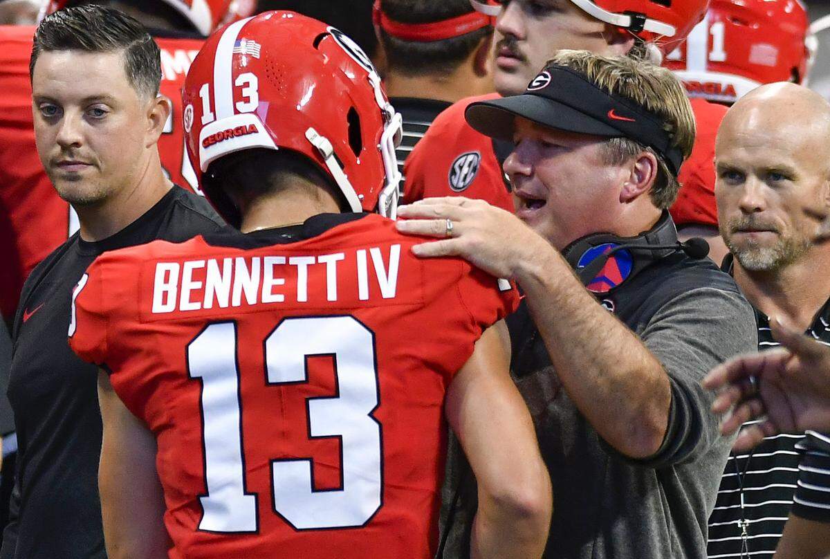 Georgia coach Kirby Smart speaks with quarterback Stetson Bennett (13) during the Bulldogs’ win over Oregon Saturday in Atlanta.