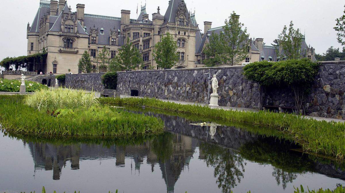 FILE- In this July 6, 2005, file photo, the Biltmore House is reflected in a pond on the estate in Asheville, N.C. Buncombe County appraisers say Biltmore House is worth about $37 million, and the nearly 2,200 acres it sits on is worth more than $64 million. The tax department says if you throw in the hotels, restaurants, outbuildings and private residences, the total value of the public areas of Biltmore Estate is nearly $300 million. (AP Photo/Chuck Burton, File)