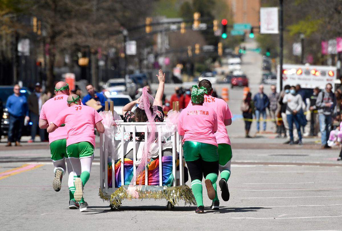 The Mattress Firm bed races down Cherry Street Saturday during the Cherry Blossom Festival Bed Race.