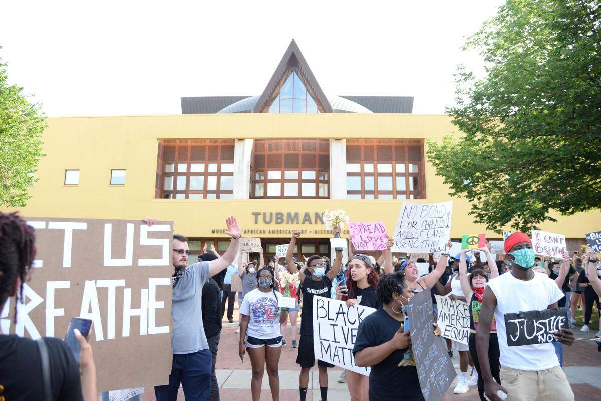 Marchers gather in front of the Tubman Museum in Macon Tuesday evening after walking through downtown. The museum’s purpose is to educate people on African American history and culture.