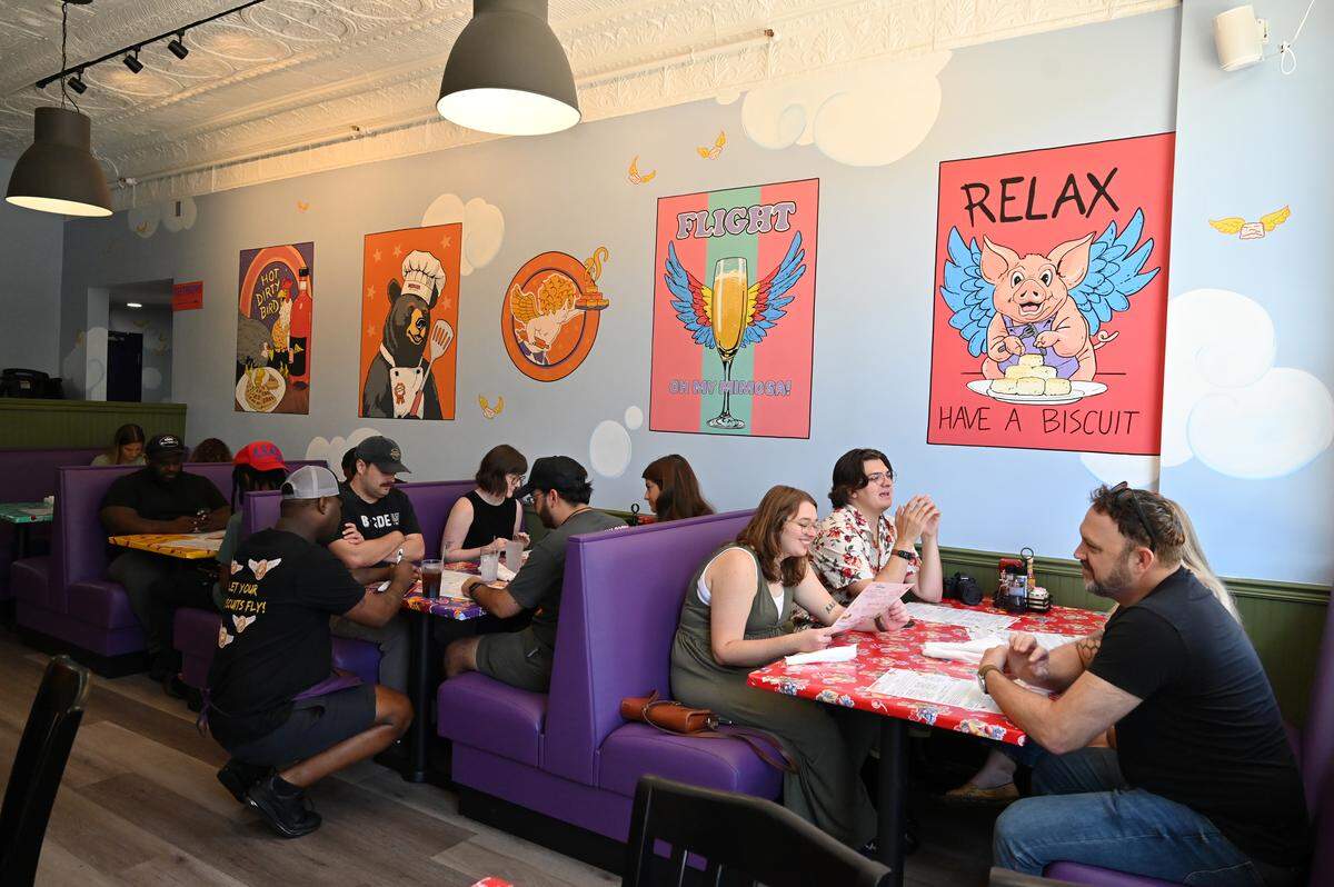 Patrons sit inside the back room of Flying Biscuit Cafe during their soft opening on Saturday, July 26, 2025, in Macon, Georgia. The Atlanta-based breakfast and lunch restaurant opened its 40th location in downtown Macon on Monday. 