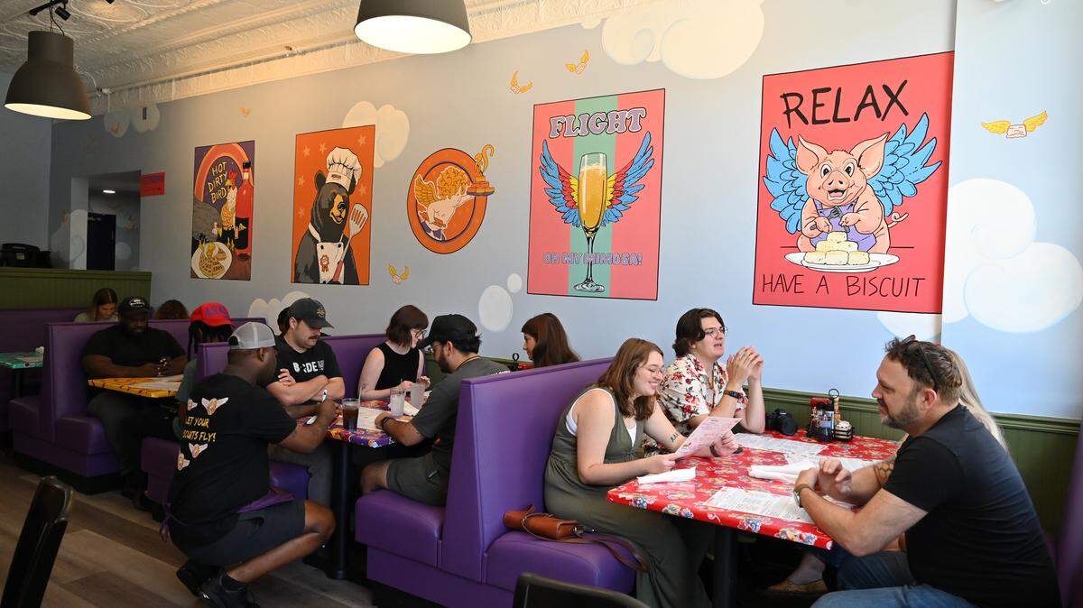 Patrons sit inside the back room of Flying Biscuit Cafe during their soft opening on Saturday, July 26, 2025, in Macon, Georgia. The Atlanta-based breakfast and lunch restaurant opened its 40th location in downtown Macon on Monday.