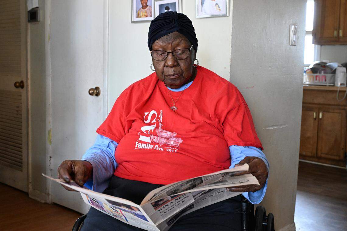 Willie Maude Lumpkin, 96, flips through a 2002 Museum of Aviation brochure highlighting the Tuskegee Airmen exhibit at her home on Thursday, Feb. 26, 2026, in Warner Robins, Georgia. Her older brother Richard Davis served as one of the original Tuskegee Airmen in World War II and was killed in a training accident in 1943.