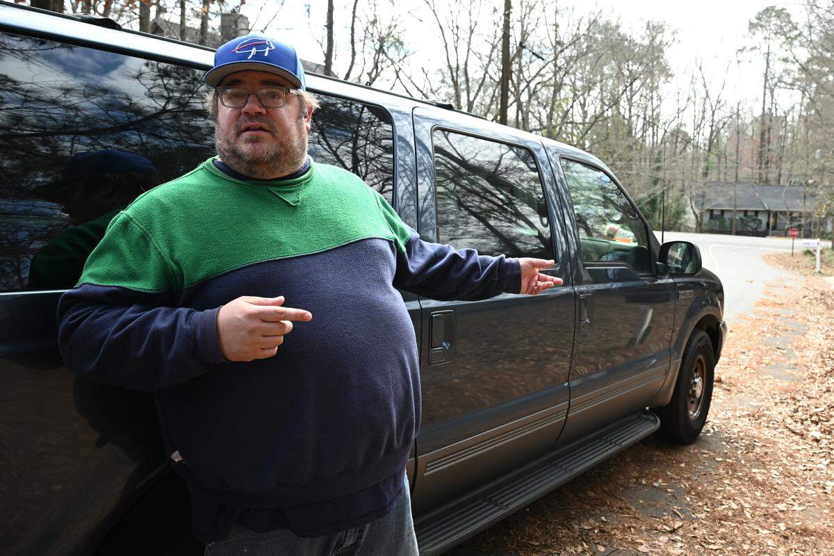 Scott Bogulski, from Forsyth, stands outside of the home on Ridgeview Circle where a man allegedly killed his wife, daughter and pets in the Lake Wildwood Neighborhood on Wednesday, Feb. 18, 2026, in Macon, Georgia. Bolguski travels across Georgia as a crime scene cleaner and left his information at the house for extended family or a landlord.