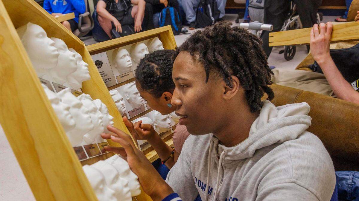 Georgia Academy for the Blind senior Daquan Brown with the 3d yearbook printed for him and other members of the Class of 2023 by Mercer University engineering students.