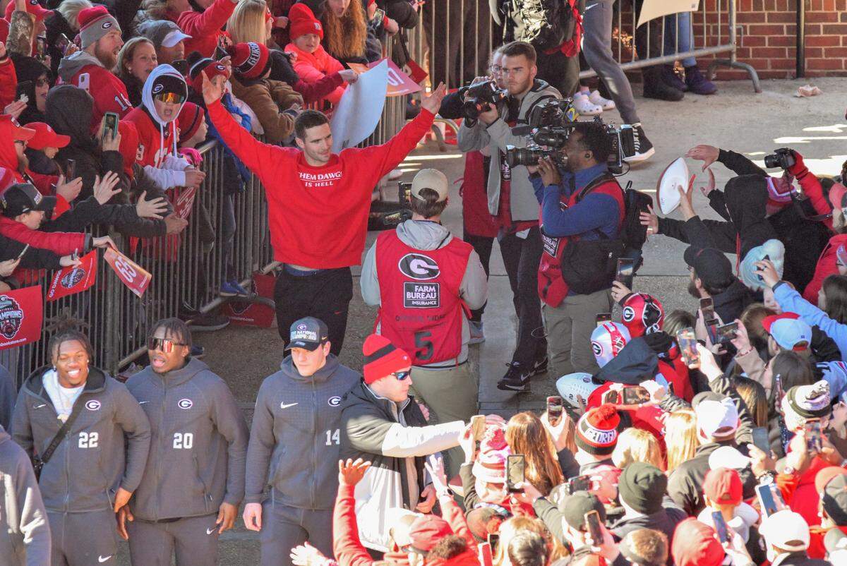 Georgia quarterback Stetson Bennett acknowledges the crowd gathered in Athens Saturday during the Bulldogs’ National Championship celebration.