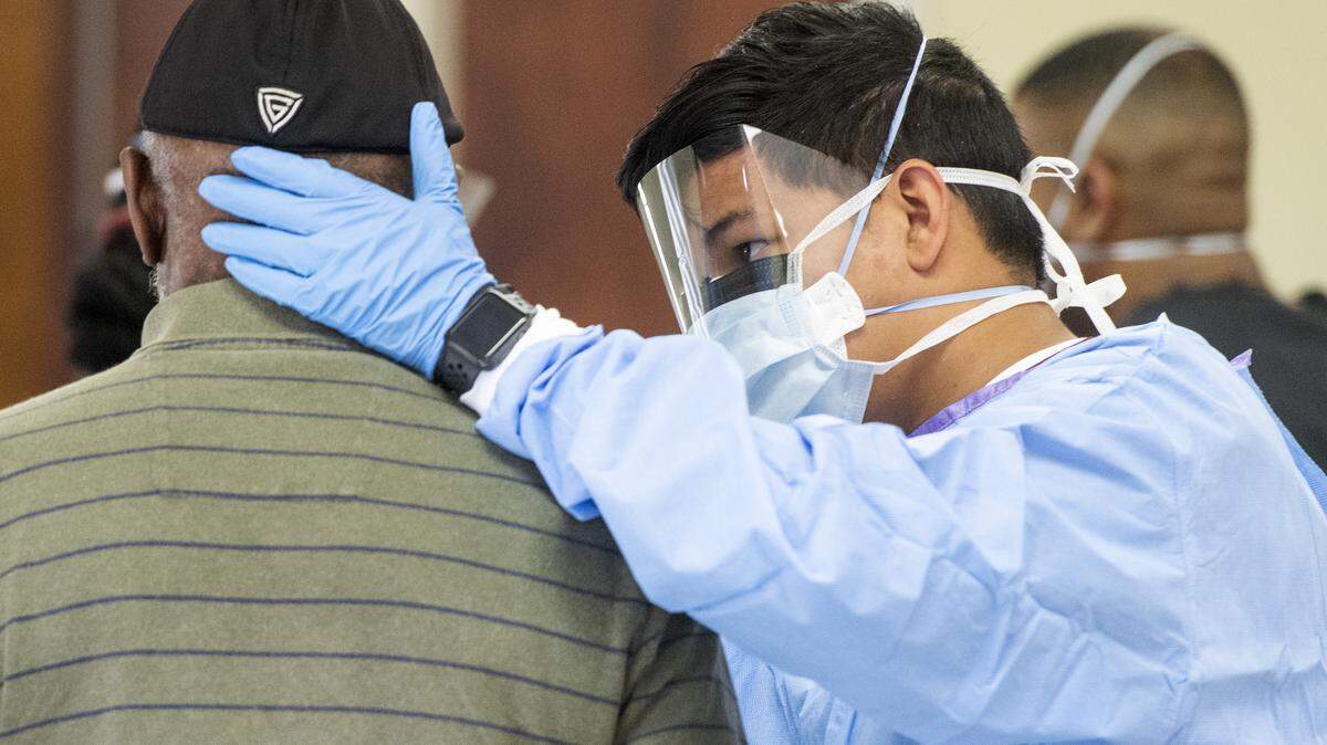 JASON VORHEES/THE TELEGRAPH Macon, GA, 04282020 Spc. Madhee Sarrtsud with the 148th Brigade Support Battalion performs a deep nasal swab COVID-19 test Tuesday at Ebenezer Missionary Baptist Church.