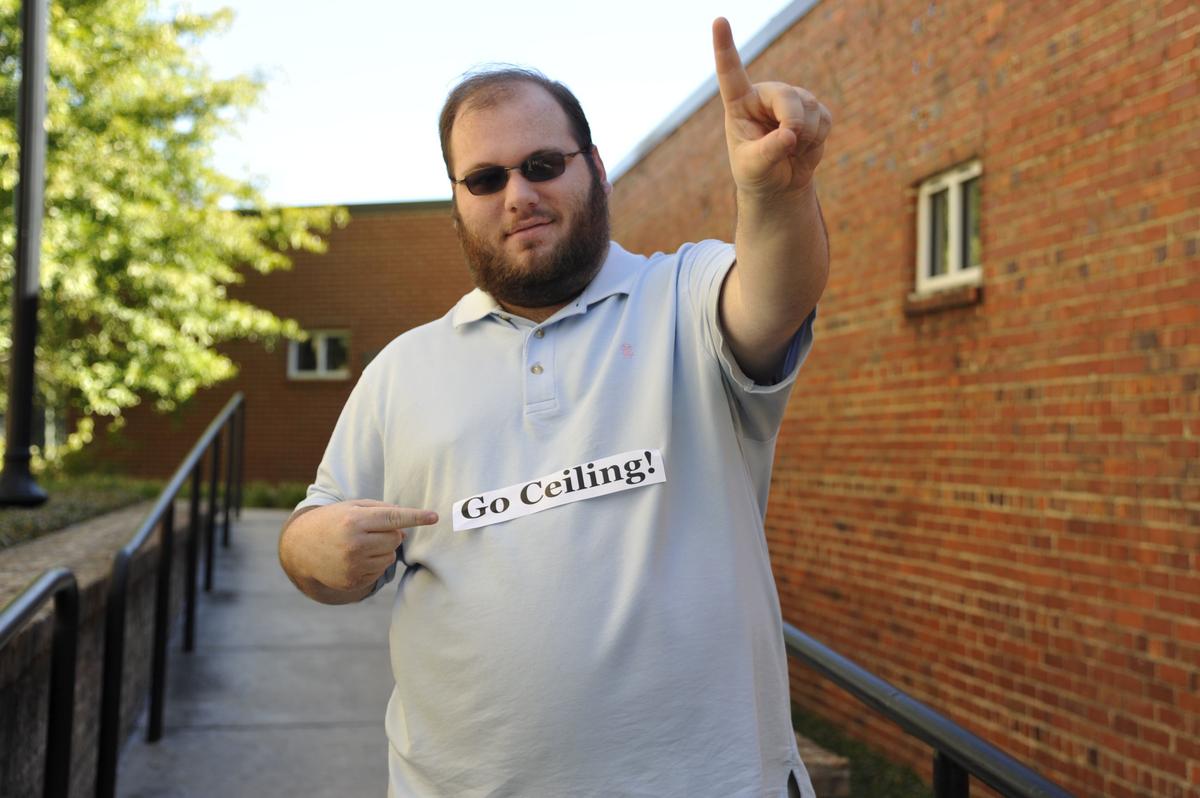 Justin Baxley, a reporter with The Macon Telegraph, models a halloween costume called “The ceiling fan.”