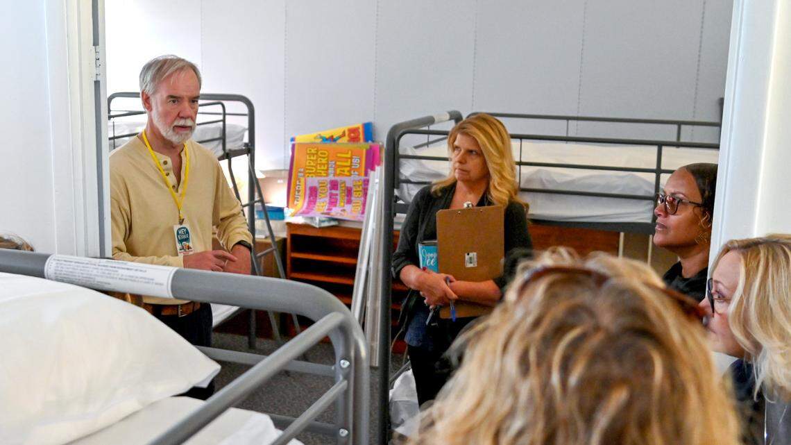 Steven Kidd, director of The Table Warming Center gives a tour of the center to volunteers Friday. The warming center is scheduled to open Monday.