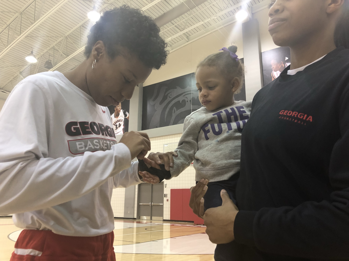 Georgia athletic trainer Maria White tapes Jacie Taylor’s wrist during a Tuesday practice at Stegeman Coliseum.