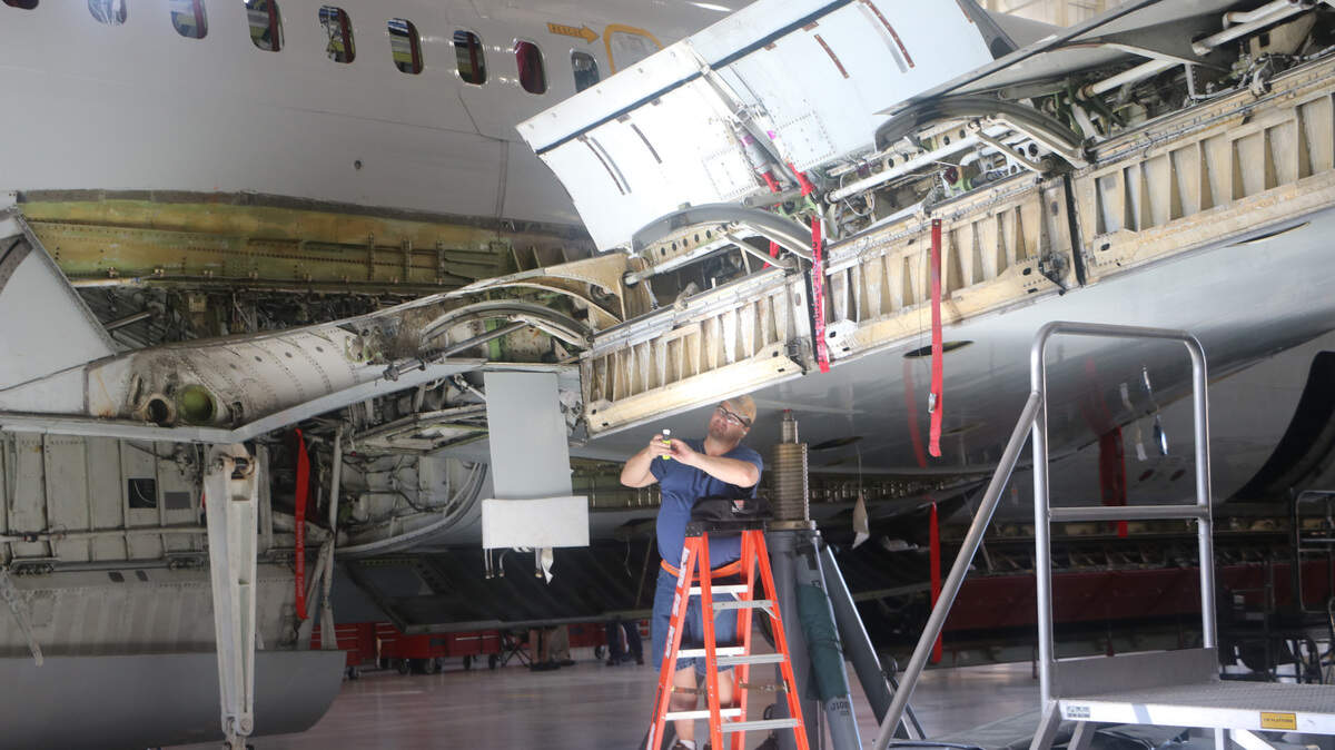 Aircraft maintainer Alvin Beck inspects doors on a a wing of the first J-STARS plane to undergo overhaul maintenance at Robins Air Force Base.