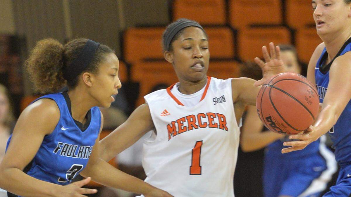 Mercer's Sydni Means (1) steals the ball from Faulkner's China Leary during first-half action Sunday.