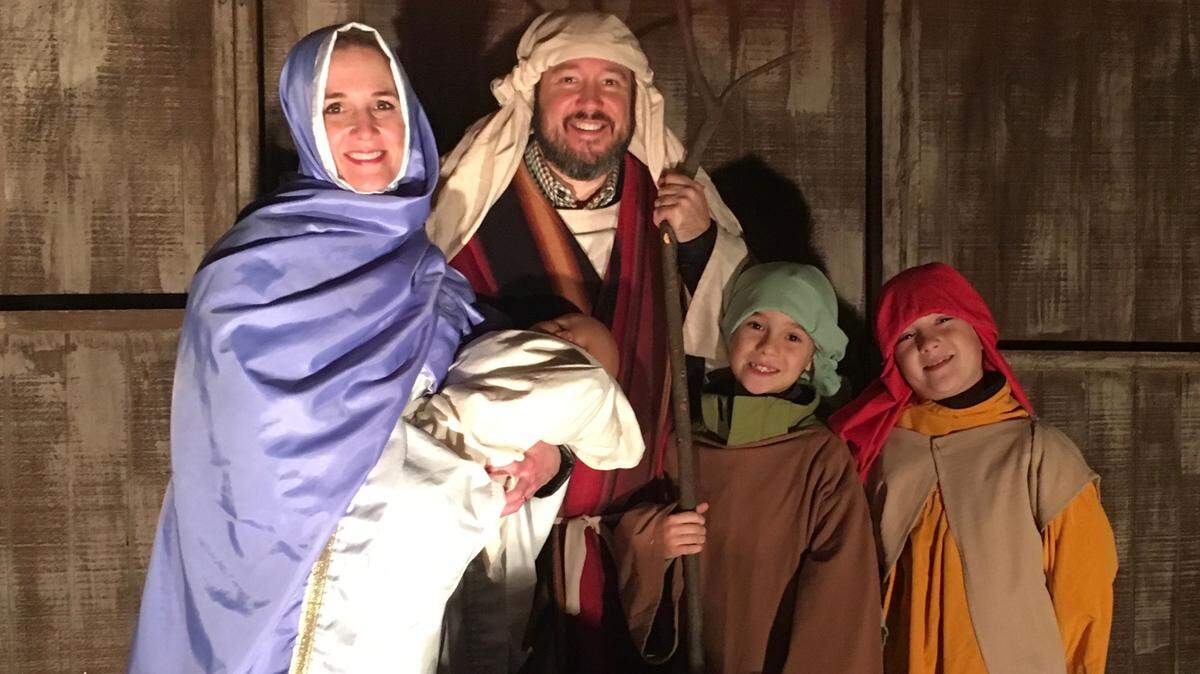 The Moodys as Mary and Joseph in manger with twin sons Barrett, left, and Walter as shepherds.