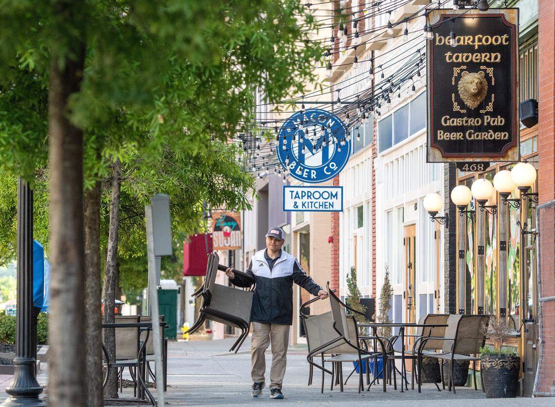 JASON VORHEES/THE TELEGRAPH Macon, GA, 04292020 Cesare Mammarella, owner of Bearfoot Tavern, puts out chairs in front of the restaurant on 2nd Street Wednesday morning. Mammarella decided to open the dining room starting Wednesday after being closed over 5 weeks during the COVIS-19 pandemic.