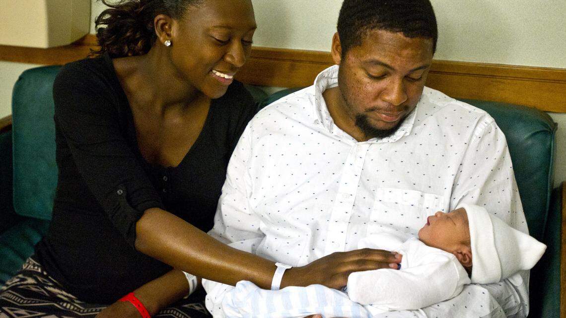 Ebony Huffman and Theron Bailey hold their newborn son, Gabriel Mychael Bailey, on Friday. Gabriel was the first baby born in the midstate in 2016.