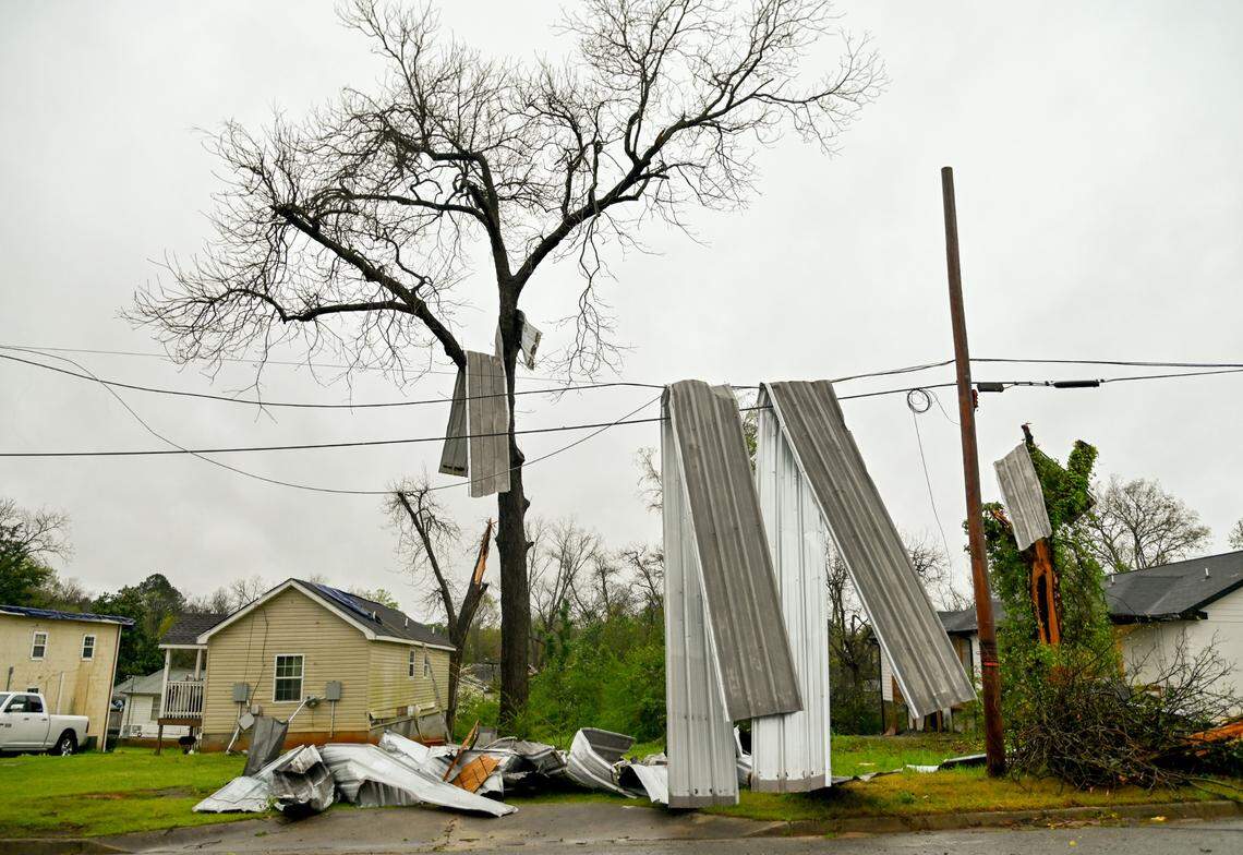 Sheet metal hangs on power lines and a tree fell on N. Wilkinson Street in Milledgeville after strong storms rolled through over the weekend.