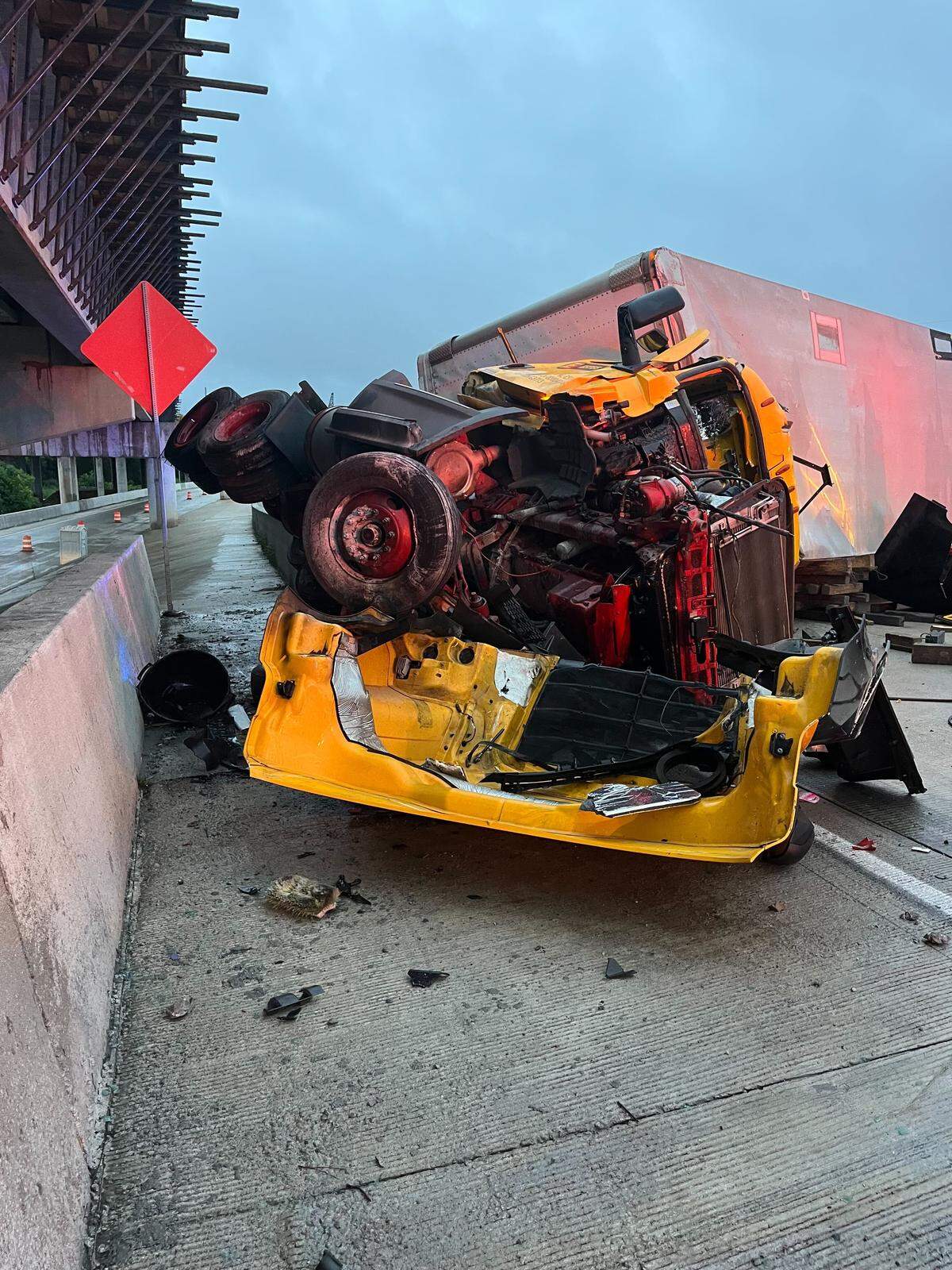 The front end of a tractor-trailer was crushed and totaled, and its back end was tilted on its side in a fatal crash on Wednesday, Aug. 6, 2025, on Interstate 16 Eastbound in Macon, Ga.