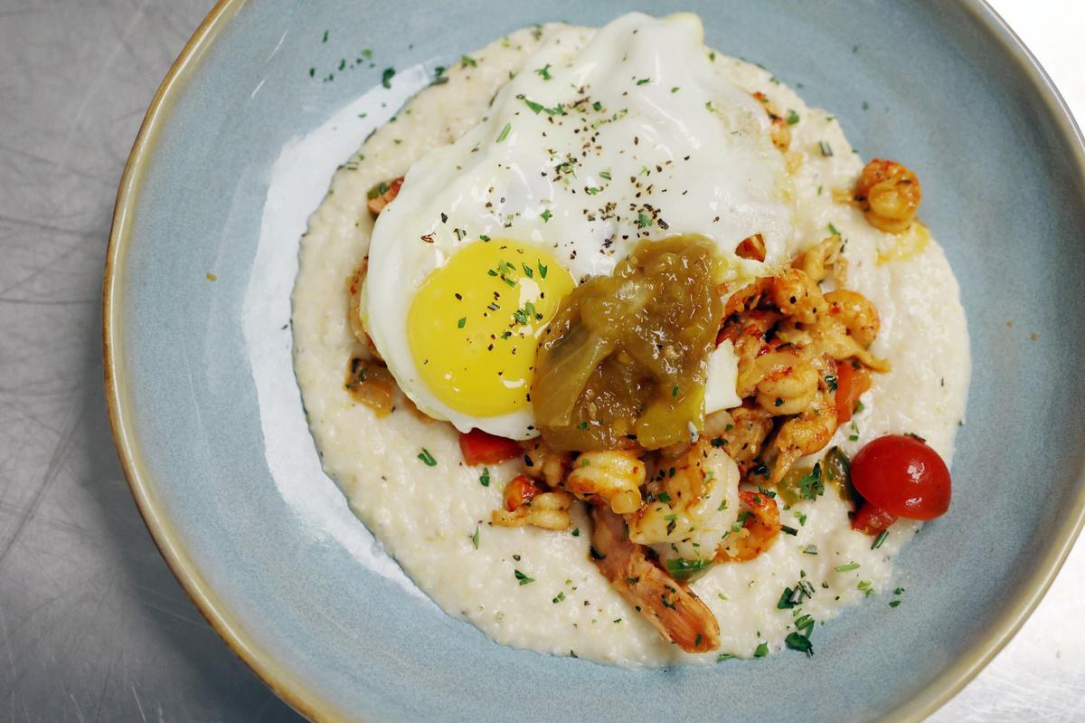 A shrimp and oyster grits breakfast dish sits onthe countertop in the kitchen at Loom inside of Hotel Forty-Five on Tuesday, Aug. 6, 2024, in downtown Macon, Georgia. Tuesday marked only the second day of breakfast service at Loom, a new addition since Reynolds’ hiring. Reynolds said that he is still working to perfect the menu and establish an identity for Loom under his leadership.