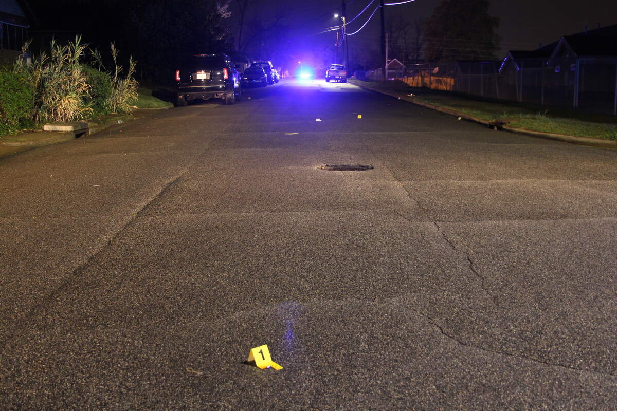 Evidence markers on Cynthia Avenue where bullet shell casings were found the night Tarus Fair was slain.