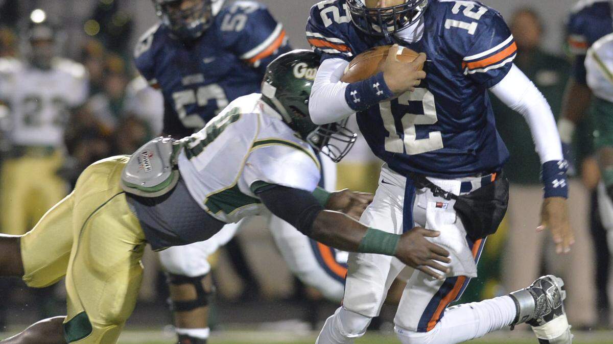 Northside quarterback Tobias Oliver (12) runs for a first half first down against Ware County on Saturday.