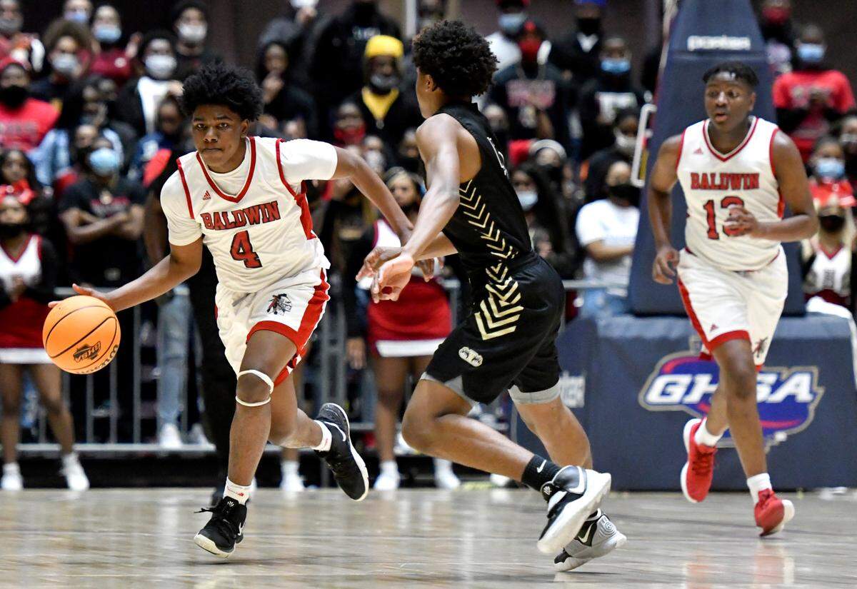 BaldwinÕs Lataeveon Roach (4) drives the ball up court during the BravesÕ GHSA 4A State Championship game against Fayette County Wednesday night in Macon.