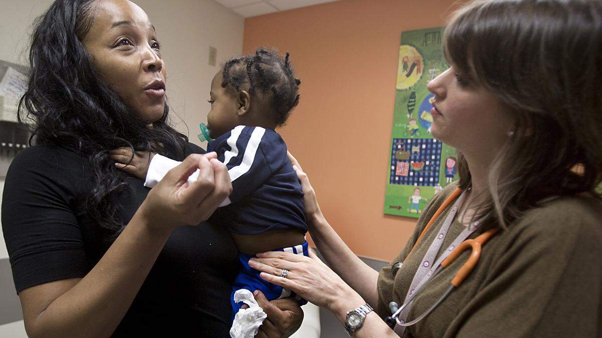 Gwendolyn Tsawo visits with Dr. Megan Butler, right, a pediatric gastroenterologist during her son Elijah's monthly checkup in December in Durham, North Carolina.