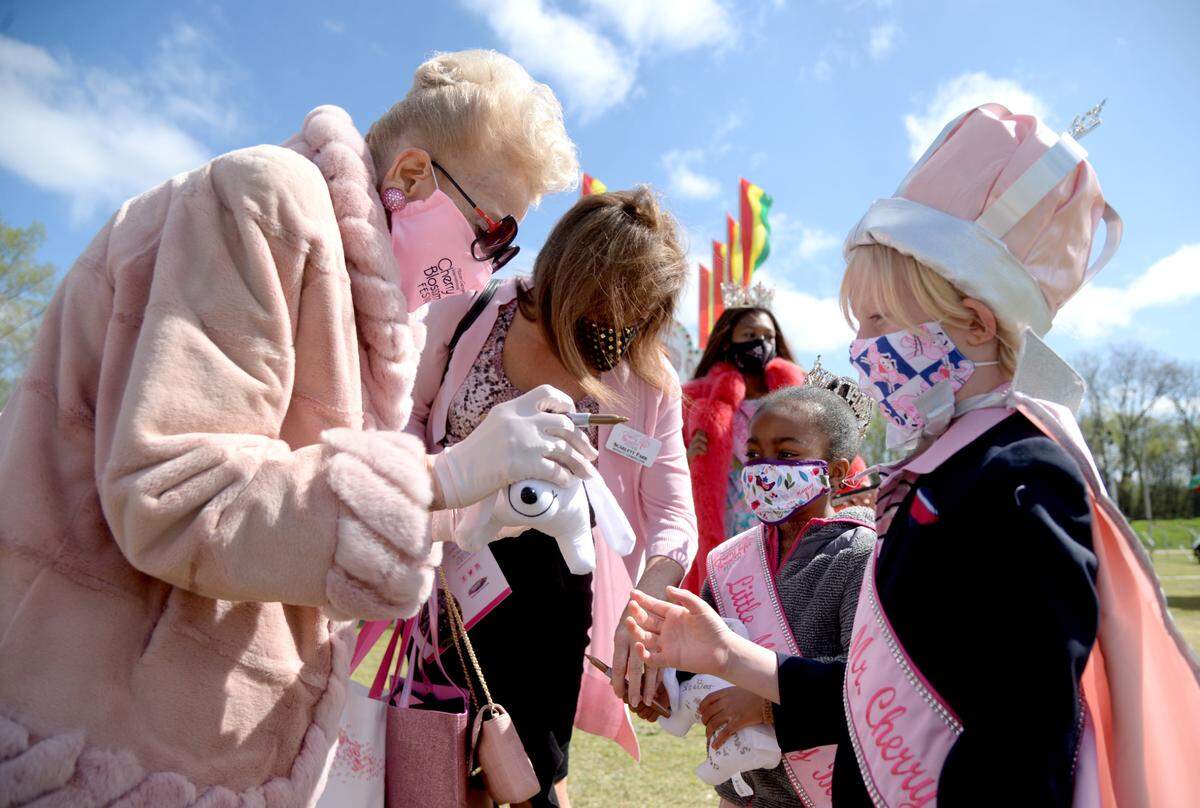 Cherry Blossom Festival founder Carolyn Crayton signs on autograph for Little Mister Walden Weatherford Friday prior to the opening ceremonies for the festival in this Telegraph file photo.