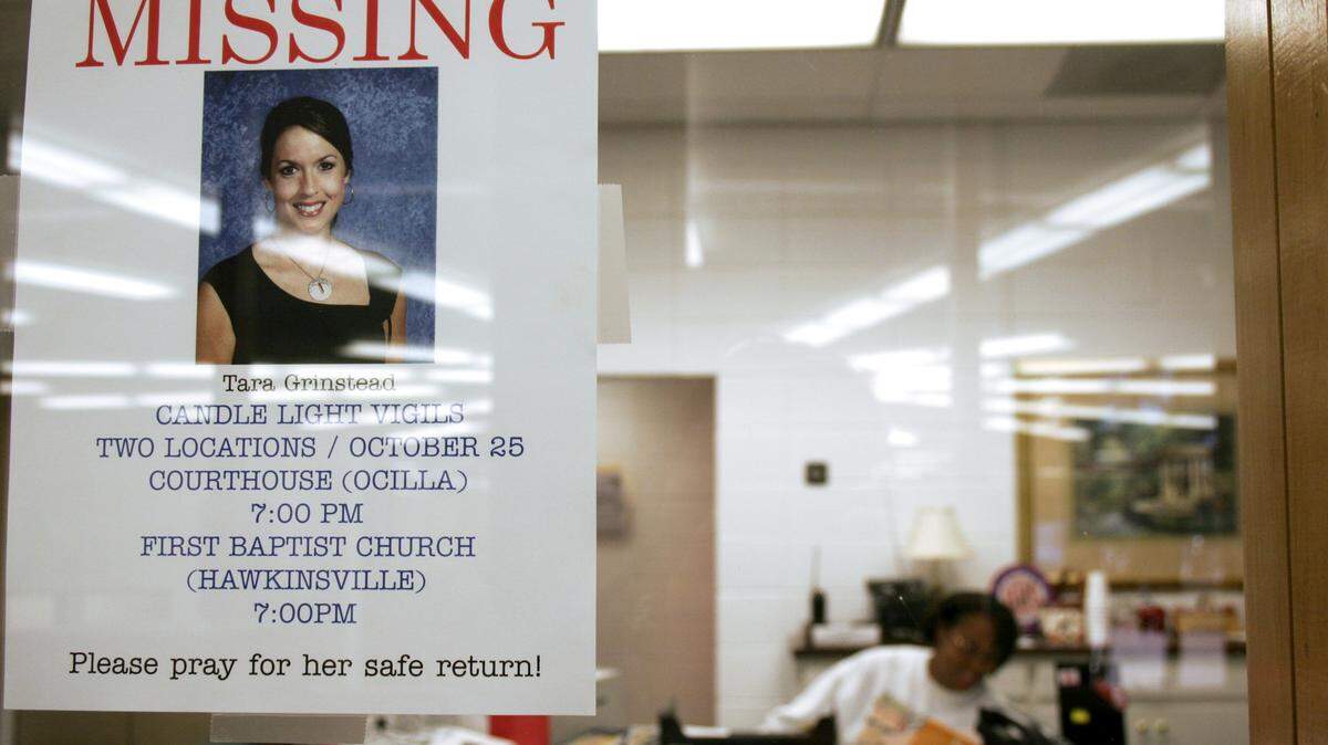 TELEGRAPH FILE PHOTO
A missing person flier for Tara Grinstead is taped to the window of the Hawkinsville High School front office window in October 2005. Grinstead was a beauty queen who graduated from Hawkinsville High and taught at Irwin County High in Ocilla.